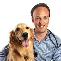 Andrew Grange sitting with his Golden Retriever dog