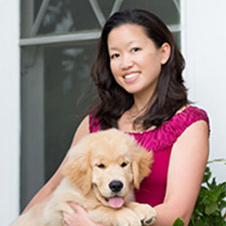 Christine Kim holding a Golden Retriever puppy