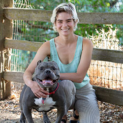 Edith Blair sitting with her gray Pitbull