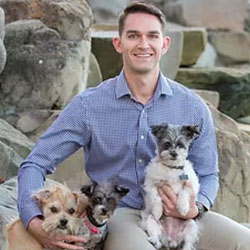 Jamie Wignall holding his three dogs