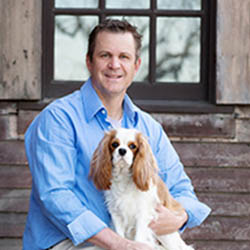 Dr. John Haburjak holding a Cocker Spaniel on his lap